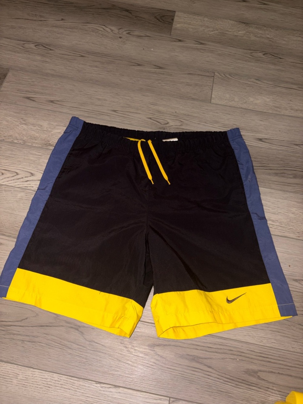 Nike Men’s Black Athletic Shorts with Yellow Hem and Blue Side Panels